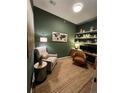 Cozy home office with built-in shelving, earth tone color scheme, and ample workspace at 15455 Canyon Rim Dr # 307, Englewood, CO 80112