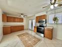 Spacious kitchen with ample cabinetry, stainless steel appliances, and tiled floor at 200 Perry St, Denver, CO 80219