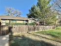 Exterior view showing a weathered wood fence enclosing the front yard at 200 Perry St, Denver, CO 80219