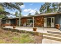 Inviting front porch with white columns, rocking chairs, brick accents, and a cheerful entry at 19070 White Fawn Dr, Monument, CO 80132