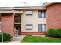 Exterior view showing brick and stucco accents, a stairway, and manicured lawn at 595 Manhattan Dr # 203, Boulder, CO 80303