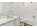 A bright bathroom with a shower-tub combo, white subway tiles, and a sleek white vanity at 9132 Telluride Ct, Commerce City, CO 80022