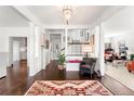 Bright foyer features gleaming hardwood floors, white columns and trim, and views of the staircase and living spaces at 3109 E Warren Ave, Denver, CO 80210