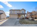 Two-story house with a brick and siding exterior, a large driveway, and landscaping at 16218 Windy Creek Dr, Monument, CO 80132