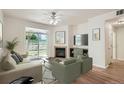 Bright living room with a fireplace, modern furnishings, and sliding glass doors leading to a private outdoor space at 8500 E Jefferson # 3C, Denver, CO 80237