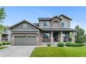 Charming two-story home with a well-maintained front yard and inviting stone-accented entrance at 13673 Osage St, Broomfield, CO 80023