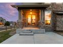 Inviting front porch with stone columns and a bright, welcoming entrance at 13673 Osage St, Broomfield, CO 80023