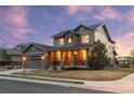 Beautiful two-story home featuring stone accents, a covered porch, and manicured landscaping at 13673 Osage St, Broomfield, CO 80023