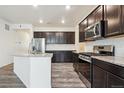 Modern kitchen with stainless steel appliances and granite counters at 26774 E Archer Ave, Aurora, CO 80018