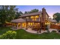Backyard featuring a two-level deck, outdoor seating, and mature trees providing shade at 11796 W 53Rd Pl, Arvada, CO 80002