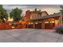 Rear view of a house, featuring a three-car garage, a fenced yard, and a multi-level deck at 11796 W 53Rd Pl, Arvada, CO 80002