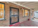 Close up of the front door and windows in a charming brick home at 2866 Bellaire St, Denver, CO 80207