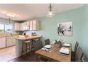 Cozy dining area has a breakfast bar, counter seating, and neutral-toned decor, creating a comfortable dining space at 8635 Clay St # 417, Westminster, CO 80031