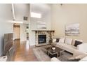 Inviting living room with stone fireplace, hardwood floors and white sectional at 8635 Clay St # 417, Westminster, CO 80031