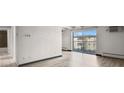Bright living room featuring a walk-out balcony with decorative railings and neighborhood views at 100 S Clarkson St # 303, Denver, CO 80209