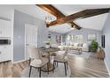 A cozy room with natural wood beams, laminate floors, and modern decorations at 1255 Nelson St, Lakewood, CO 80215