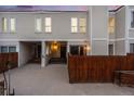 The front exterior of a townhome features wood fencing, siding, and covered parking at 1050 S Monaco Pkwy # 77, Denver, CO 80224