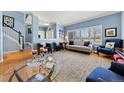 Spacious living room featuring wood floors, modern furniture, and natural light from the front windows at 120 S Locust St, Denver, CO 80224