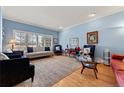 Bright living room featuring hardwood floors, large windows and a neutral color palette throughout at 120 S Locust St, Denver, CO 80224