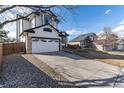 Well-maintained home with attached garage and a long driveway offering plenty of parking space at 1314 Ascot Ave, Highlands Ranch, CO 80126
