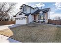 Charming two-story home with a well-manicured lawn, a two car garage, and a fire pit at 1314 Ascot Ave, Highlands Ranch, CO 80126