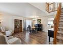 Open-concept living room with hardwood floors, staircase and space for dining at 9457 Morning Glory Ln, Highlands Ranch, CO 80130