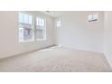 Well-lit bedroom featuring neutral carpet and windows at 2098 S Haleyville Way, Aurora, CO 80018
