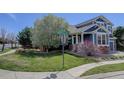 Well-manicured lawn and landscaping surround this beautiful two-story home on a sunny corner lot at 9996 Sedalia St, Commerce City, CO 80022