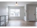 Bright living room features a large window and an entrance door at 10035 E Carolina Pl # 201, Aurora, CO 80247