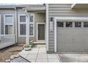 Inviting entrance to a home with a gray exterior, a small porch, and an attached one-car garage at 3228 47Th, Boulder, CO 80301