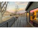 Deck overlooks scenic landscape, offering captivating sunset views at 5370 Pine Ridge Rd, Golden, CO 80403