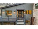 Modern front entrance with sleek black door and a welcoming deck at 5370 Pine Ridge Rd, Golden, CO 80403