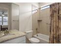 Bright bathroom with shower-tub combo, white vanity, and tile details at 7965 S Vandriver Way, Aurora, CO 80016