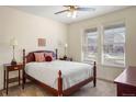 Well-lit bedroom with a comfortable queen bed, ceiling fan, and a lot of light at 7965 S Vandriver Way, Aurora, CO 80016