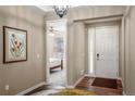 Bright entryway with hardwood floors and views into the bedroom at 7965 S Vandriver Way, Aurora, CO 80016