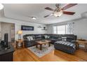 Spacious living room with hardwood floors, sectional sofa, and fireplace at 7674 Stuart St, Westminster, CO 80030