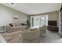 Comfortable living room featuring a neutral color palette, balcony access, and plush seating at 610 S Clinton St # 3D, Denver, CO 80247
