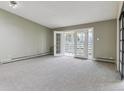 Spacious living room with a large window and sliding doors to a balcony, offering ample natural light at 610 S Clinton St # 3D, Denver, CO 80247