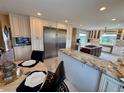 Open kitchen area showcasing stainless steel appliances, granite countertops, and eat-in area at 1063 Clarke Ct, Castle Rock, CO 80109