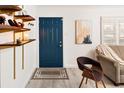 Bright entryway with a navy blue door and wood shelves at 1171 Quebec St, Denver, CO 80220