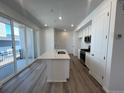 Modern kitchen features a large center island, stainless steel appliances, and sliding doors to a deck at 6638 N Nepal Ct, Aurora, CO 80019
