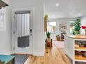 Bright entryway leading to an open-concept living space with hardwood floors at 1303 Jersey St, Denver, CO 80220