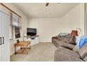 Comfortable living room features a plush sofa, a TV, and large windows for natural light at 12764 Ironstone Way # 103, Parker, CO 80134