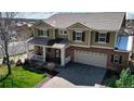 Spacious two-story home with a well-manicured lawn, brick accents, and a two-car garage at 23426 E Ottawa Dr, Aurora, CO 80016
