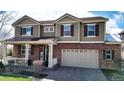 Well-maintained two-story home with brick accents, shutters, manicured lawn and attached two-car garage at 23426 E Ottawa Dr, Aurora, CO 80016