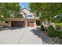 Charming exterior with three-car garage, manicured yard and front porch at 3901 Stonegrass Pt, Broomfield, CO 80023