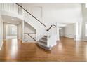Grand foyer features high ceilings, hardwood floors, and a sweeping staircase at 3901 Stonegrass Pt, Broomfield, CO 80023