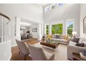 Bright living room boasts soaring ceilings and oversized windows at 3901 Stonegrass Pt, Broomfield, CO 80023