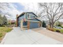 Charming two-story home with blue siding, brick accents, two car garage, and spacious driveway at 4620 W 108Th Pl, Westminster, CO 80031