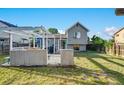 A backyard with a wooden deck, grill, and a spacious lawn, perfect for outdoor enjoyment at 16980 E Stanford Ave, Aurora, CO 80015